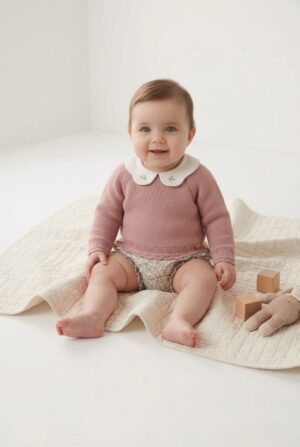 Conjunto de primera puesta para bebé con jubón y polaina en color rosa de la marca Paz Rodríguez, ideal para la canastilla del hospital.